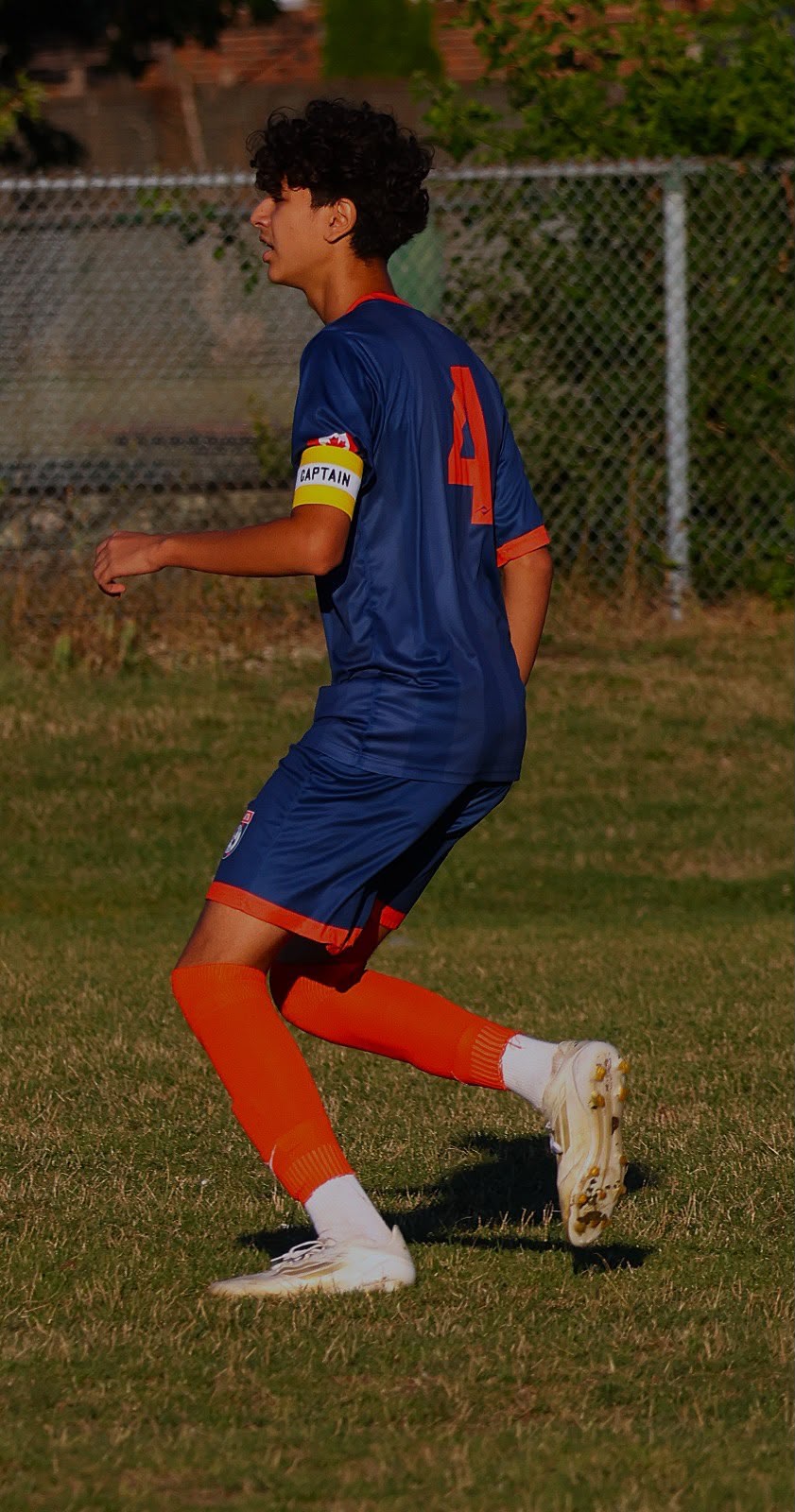 Radin Hajipour wears a Canadian flag captain's armband during youth football training in Toronto